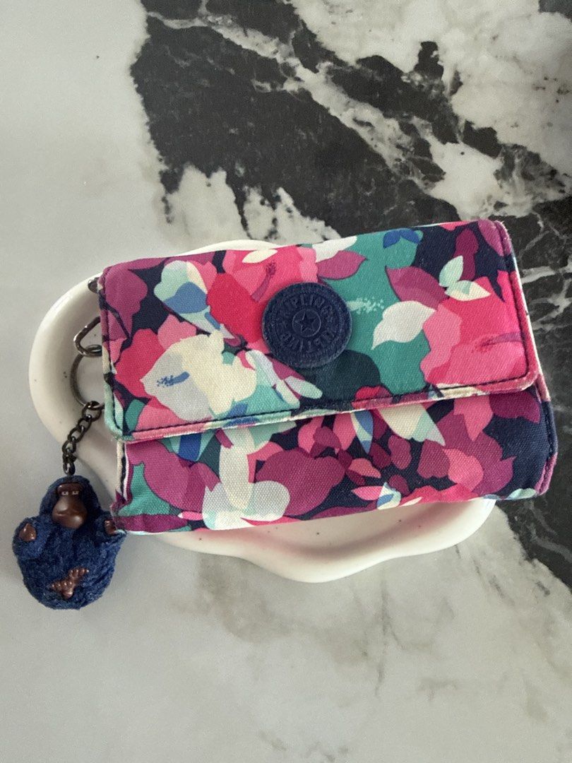 Kipling Pixi Wallet -Electric Blossom with Monkey ( Hallie) (Category: Wallets & Card holders) located in Himamaylan. Submitted by EsClosetCleanUp (Listing ID 1448100608, Image 2). Description: - Cute Kipling wallet with vibrant floral print - Multiple card slots for organization - Zippered compartment for secure storage - Iconic Kipling monkey charm included - Compact and practical for everyday use -needs cleaning.