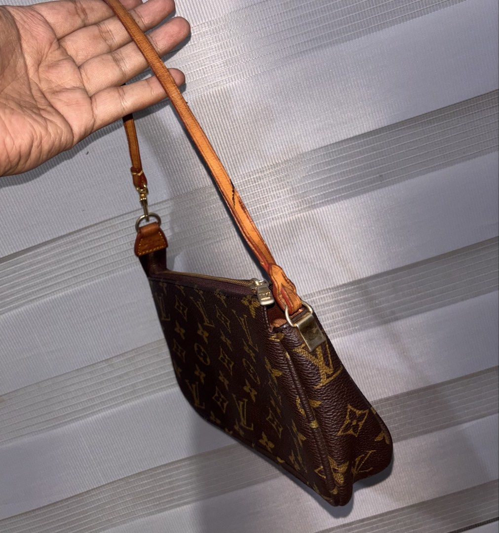 Louis Vuitton Monogram Pochette Accessoire Bag (Category: Luxury Bags & Wallets) located in Bago City. Submitted by christiaaan0515 (Listing ID 1448268447, Image 2). Description: - Louis Vuitton Monogram Pochette - Classic monogram canvas with leather trim - Secure zipper closure - Gold hardware - Compact size, ideal for essentials - Attached strap with gold D-ring - Please note: Some signs of wear on the leather strap and trim.