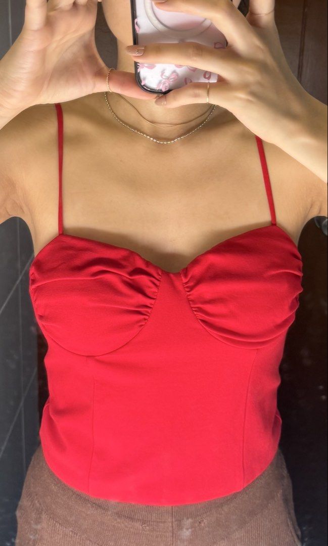 Love Bonito Red Corset Bustier Top (Category: Sleeveless) located in Quezon City. Submitted by kimtlee (Listing ID 1448111860, Image 1). Description: - Red corset bustier top from Love Bonito - Features adjustable spaghetti straps -padded, no bra needed - Sweetheart neckline with ruched detailing - Zipper closure at the back - Perfect for dressing up or down - Can be paired with jeans or a skirt.