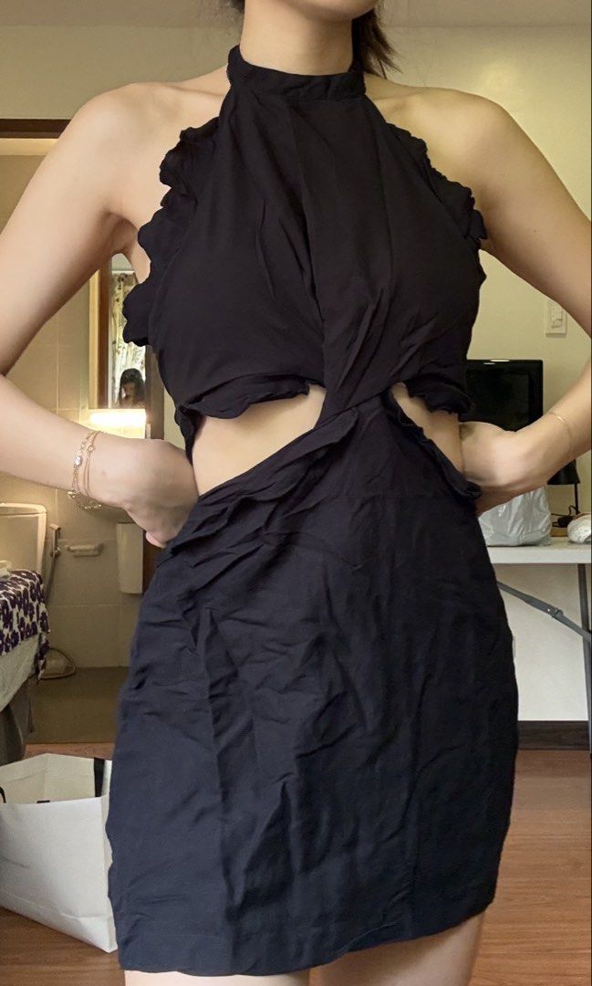 MANGO Black Halter Neck Cut-Out Dress (Category: Dresses) located in Quezon City. Submitted by kimtlee (Listing ID 1448096882, Image 1). Description: - Black MNG dress - Size: Medium (M) - Halter neck design - Trendy cut-out details - Secure tie-back closure - Elegant ruffled trim - Unique slightly crinkled fabric texture - Ideal for night outs or special occasions.
