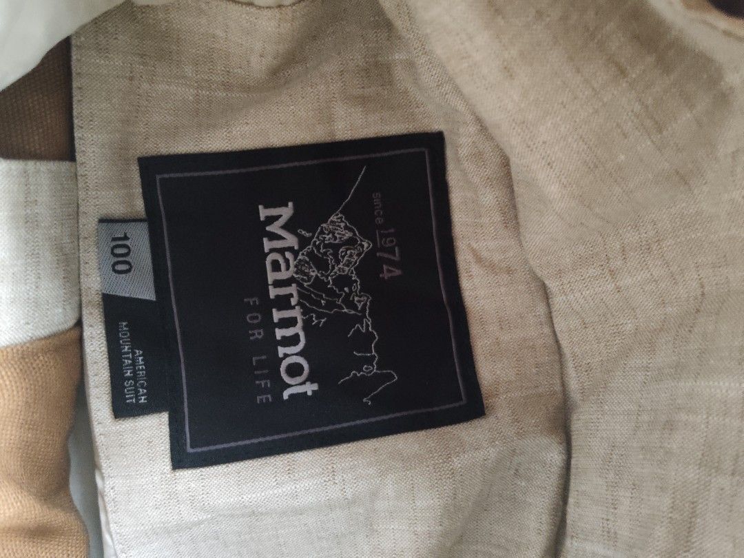 Marmot "American Mountain Suit" Jacket (Category: Coats, Jackets and Outerwear) located in Quezon City. Submitted by needforthrift (Listing ID 1448194314, Image 2). Description: - Marmot "American Mountain Suit" Jacket - Color: Light Green/Grey - Size: 100cm (Tag) - Features: Multiple front pockets, attached hood - Details: Marmot logo on buttons - Origin: Made in Vietnam - Ideal for: Outdoor activities, hiking, camping.