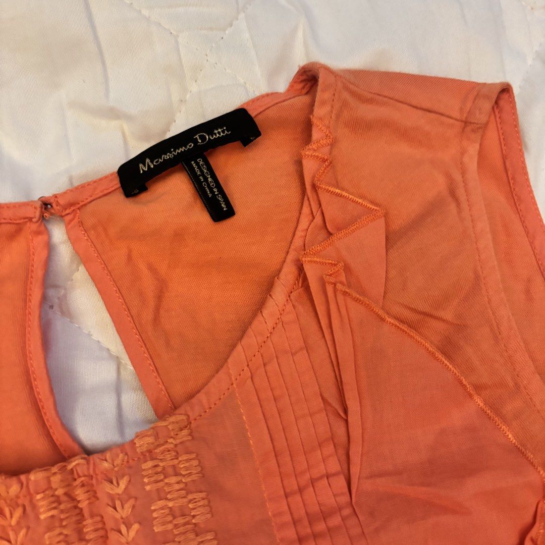 Massimo Dutti Orange Sleeveless Ruffled Embroidered Top (Category: Sleeveless) located in Angono. Submitted by andyyyyyy__ (Listing ID 1448183225, Image 2). Description: - Orange sleeveless top - Brand: Massimo Dutti - Features: Ruffles on sides, embroidered panel on front - Closure: Keyhole at back neck - Condition: Minor dark marks on front left side (as pictured) - Style: Great for casual wear.