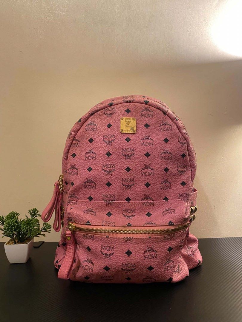 MCM Stark Side Stud Visetos Pink Backpack (Category: Luxury Bags & Wallets) located in Cagayan de Oro. Submitted by timeless.ph (Listing ID 1448260345, Image 3). Description: Size: Medium Width: 13.5” with Laptop Compartment Length: 11” Condition: Rank AB Issue/s: minor rubber lining & stain (need wash) & rubs *color may vary due to lighting*.