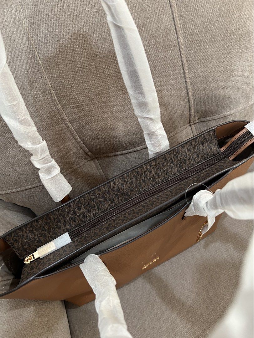 Michael Kors Arden Tote Bag Large- Brown Monogram (Category: Shoulder Bags) located in Santa Rosa. Submitted by megally (Listing ID 1448273193, Image 3). Description: - Authentic Brown Michael Kors Tote Bag - Signature MK Monogram Print Interior - Genuine Leather Exterior - Elegant Gold MK Charm Accent - Spacious Interior for All Your Essentials - Handles Still Protected with Original Plastic Wrap -Large Size can fit laptop Available for Grab,lal