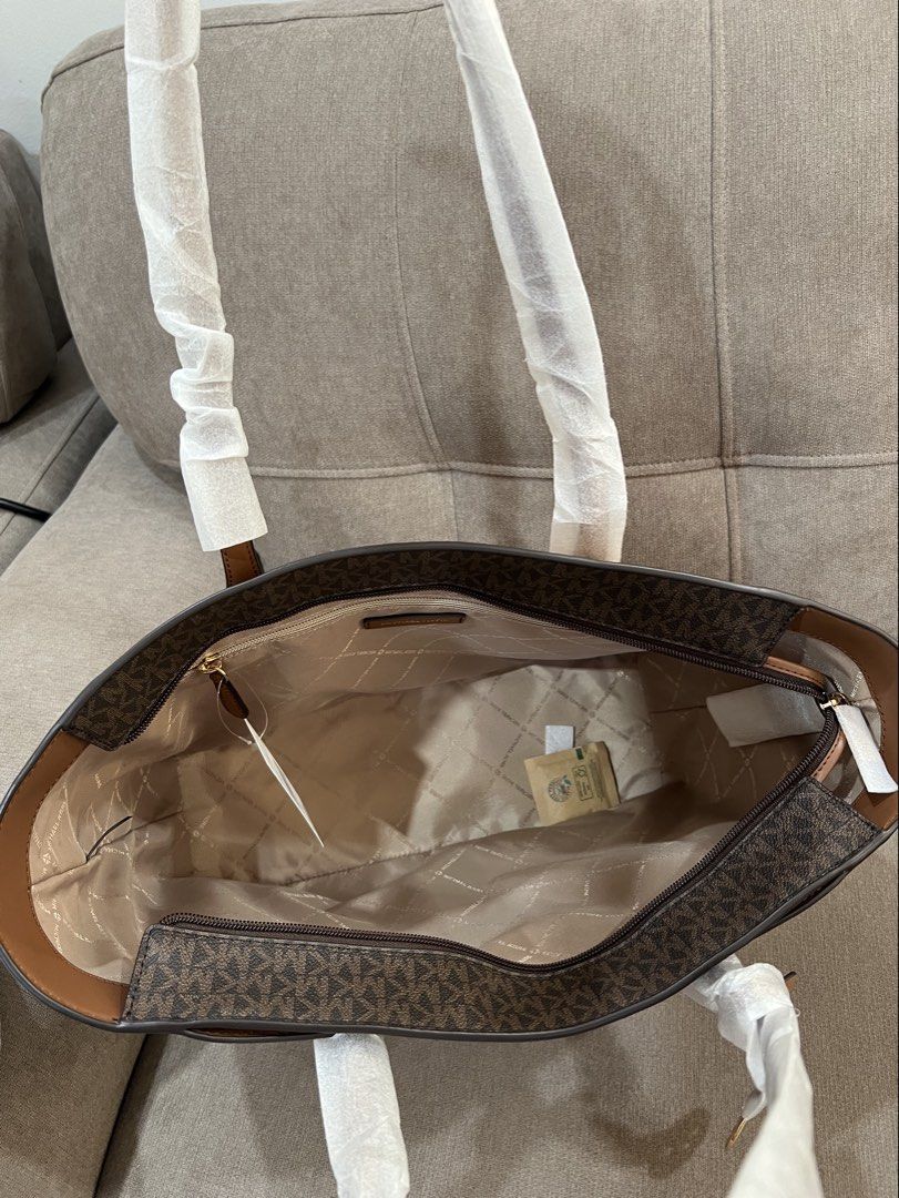 Michael Kors Arden Tote Bag Large- Brown Monogram (Category: Shoulder Bags) located in Santa Rosa. Submitted by megally (Listing ID 1448273193, Image 2). Description: - Authentic Brown Michael Kors Tote Bag - Signature MK Monogram Print Interior - Genuine Leather Exterior - Elegant Gold MK Charm Accent - Spacious Interior for All Your Essentials - Handles Still Protected with Original Plastic Wrap -Large Size can fit laptop Available for Grab,lal