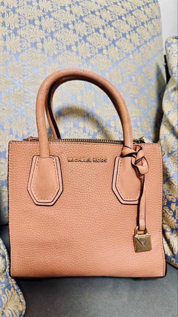 Michael Kors Pink Leather Satchel Bag (Category: Luxury Bags & Wallets) located in Tarlac. Submitted by via_banana (Listing ID 1448205684, Image 1). Description: - Cute orange-pink Michael Kors satchel - Made of genuine pebbled leather - Signature MK lock charm - Top handles for comfortable carrying - Secure zip closure - Ideal size for everyday essentials.