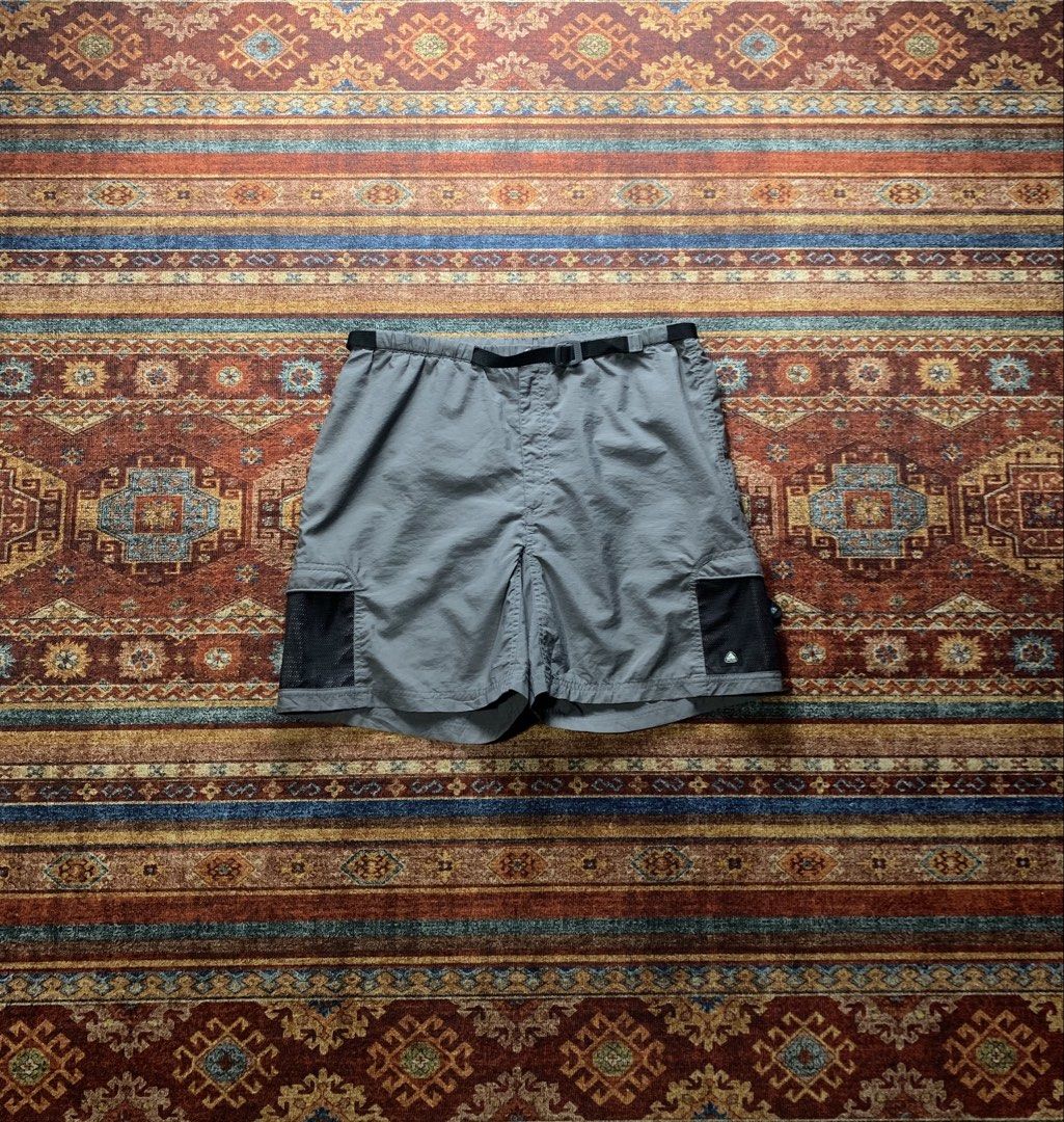Nike ACG Charcoal Grey Hiking Shorts (Category: Activewear) located in Lingayen. Submitted by hiddeninattic (Listing ID 1448255821, Image 1). Description: - Nike ACG Grey Cargo Shorts - Built-in belt with quick-release buckle - Multiple pockets, including side mesh cargo pockets - Elastic waistband for comfort - Ideal for outdoor activities and casual wear - Dimension’s Width 34-18 Length 18.