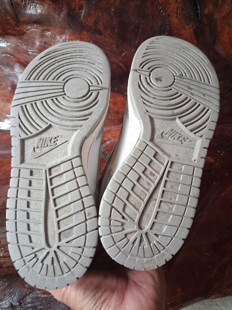 Nike Dunk Low Grey White Sneakers (Category: Sneakers) located in Manila. Submitted by beardedbot (Listing ID 1448105702, Image 3). Description: - Nike Dunks (Grey/White) - Size: 8.5Y - Condition: Used, with some scuffs on soles and minor wear on uppers. - Features: Laces with text detail. - Note: Still has a lot of life left, sold as is..