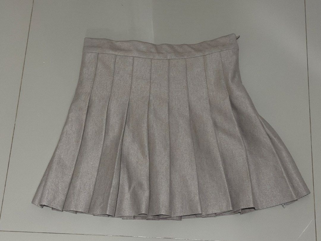 Nude Pleated Mini Skirt (Category: Skirts) located in Angeles City. Submitted by declutterwithus (Listing ID 1448197965, Image 1). Description: - Nude pleated mini skirt - Size 26-27 - Features a side zipper - Versatile for casual or dressed-up outfits - Effortless to pair with various tops and shoes.
