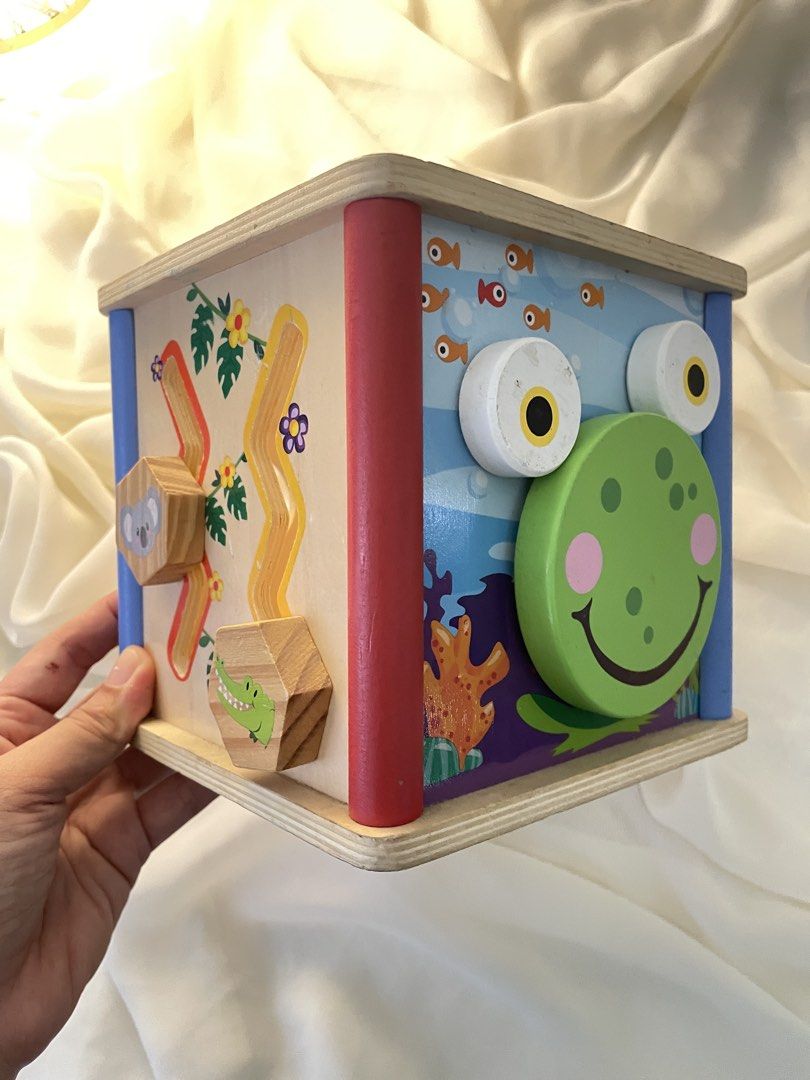 Playtive Junior 5 in 1 Wooden Activity Cube (Category: Infant Playtime) located in San Juan, La Union. Submitted by true.declutteringmomma (Listing ID 1448221989, Image 1). Description: •A wooden developmental toy for young children. •This cube includes multiple features such as a shape sorter, cog wheels, a track maze, and an illustrated clock face. •No shapes and top part included, hence the super low price..