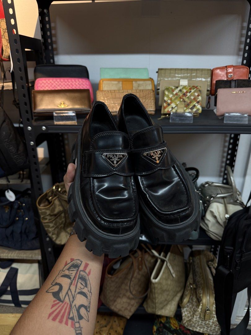 Prada Black Patent Leather Platform Loafers Size 37 (Category: Loafers) located in Legazpi City. Submitted by deadthrift (Listing ID 1448167477, Image 1). Description: - Prada Loafers - Color: Black - Material: Patent Leather - Size: 37 (EU) - Features: Chunky platform sole, iconic Prada triangle logo - Origin: Made in Italy - Style: Classic, versatile for dressing up or down.