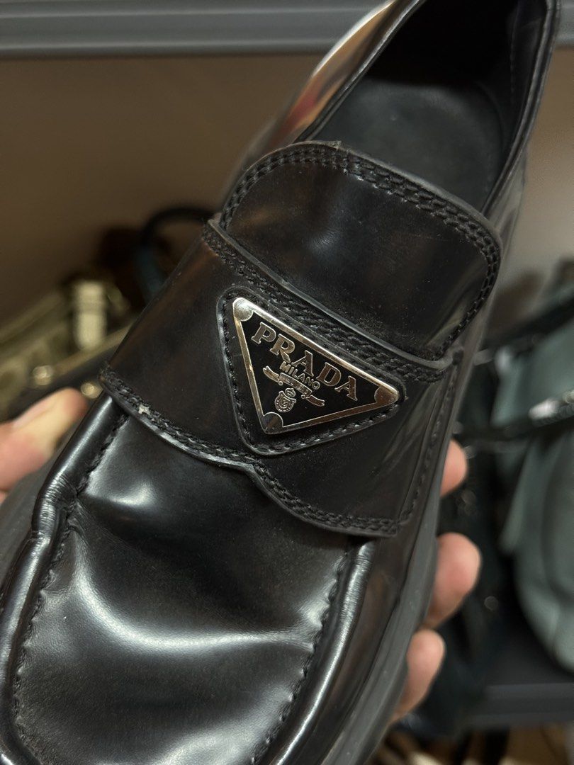 Prada Black Patent Leather Platform Loafers Size 37 (Category: Loafers) located in Legazpi City. Submitted by deadthrift (Listing ID 1448167477, Image 3). Description: - Prada Loafers - Color: Black - Material: Patent Leather - Size: 37 (EU) - Features: Chunky platform sole, iconic Prada triangle logo - Origin: Made in Italy - Style: Classic, versatile for dressing up or down.