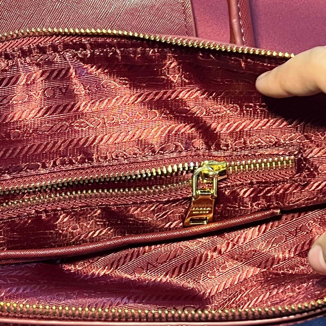 Prada Nylon & Leather Handbag (Category: Luxury Bags & Wallets) located in Batangas. Submitted by bettyboop0703 (Listing ID 1448273486, Image 3). Description: - Authentic Prada bag - Deep red nylon body - Leather trim and handles - Gold hardware details - Interior zippered pocket - Includes original dust bag - Ideal for everyday use.