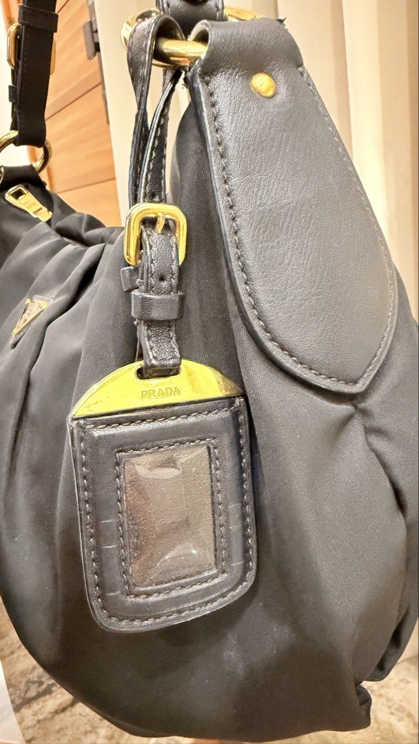 Prada Tessuto Nylon Hobo bag (Category: Luxury Bags & Wallets) located in Quezon City. Submitted by thirtyfinds (Listing ID 1448101482, Image 2). Description: - 💯 Authentic - Gold-tone hardware - Chain detailing on strap - Includes Prada leather tag - Spacious interior - Ideal for everyday use.