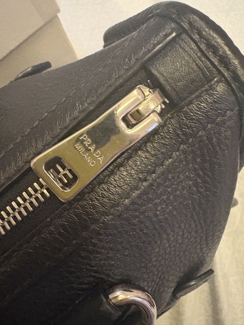 Prada Vitello Phenix leather bag small (Category: Cross-body Bags) located in Malolos. Submitted by 3Coolitz (Listing ID 1448175410, Image 3). Description: This is small size (rare size) With silver hardware With authentication With minor super small scratch pls see 8th pic Super ganda and quality leather ng Prada With long strap, pinadagdagan ko ng holes ung strap since I am a small girlie.