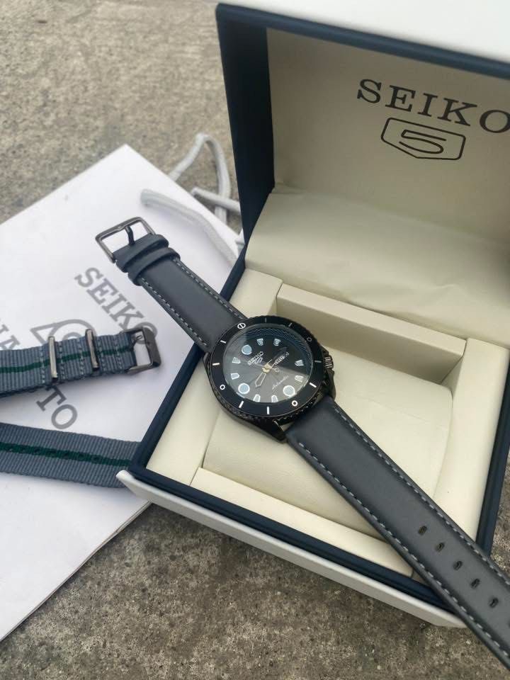 Seiko 5 Automatic Naruto Collaboration Watch (Category: Men's Watches) located in Manila. Submitted by thrifttodays. (Listing ID 1448187060, Image 3). Description: - Seiko 5 Automatic Movement watch - Black case and black dial - Comes with original Seiko box and papers - Includes a grey NATO strap with green stripes - Includes a black leather strap - Ideal for watch collectors or Naruto fans - Selling as is.