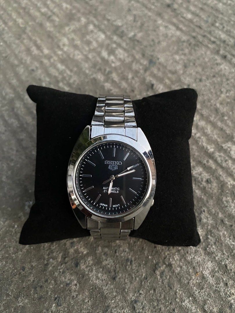 Seiko 5 Black Dial Watch (Category: Men's Watches) located in Manila. Submitted by thrifttodays. (Listing ID 1448188295, Image 2). Description: - Seiko 5 Watch - Black Dial with Silver Hands & Markers - Durable Stainless Steel Bracelet - Water Resistant - Ideal Everyday Watch.