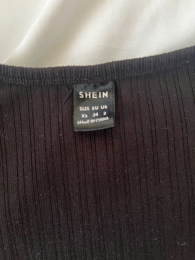 SHEIN Black Ribbed Square Neck Cap Sleeve Crop Top (Category: Blouses) located in Quezon City. Submitted by ausieeeee (Listing ID 1448122909, Image 2). Description: - Black ribbed crop top from SHEIN - Features a square neckline with a sweetheart detail - Cap sleeves - Stretchy material for a comfortable fit - Versatile: pairs well with high-waisted jeans or skirts - Easy to dress up or down for any occasion.