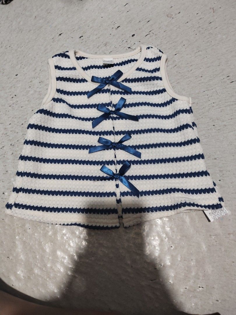 Striped Baby Vest with Bows (Category: Babies & Kids Fashion) located in Manila. Submitted by az272019 (Listing ID 1448199667, Image 2). Description: - Cute white and navy blue striped baby vest - Features adorable little blue bows down the front - Sleeveless design, ideal for layering - Made from soft knit material rfs. maliit sa anak ko.
