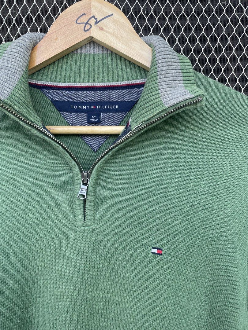 Tommy Hilfiger Green 1/4 Zip Sweater (Category: Coats, Jackets and Outerwear) located in Mataasnakahoy. Submitted by zero4thrift (Listing ID 1448097333, Image 2). Description: This Tommy Hilfiger sweater is a green cotton quarter-zip pullover featuring a small embroidered flag logo on the chest. - Green Tommy Hilfiger 1/4 zip sweater - Small flag logo on chest - Grey trim on collar - 100% Cotton - Size: S/P - Ideal for casual wear - actual size 2