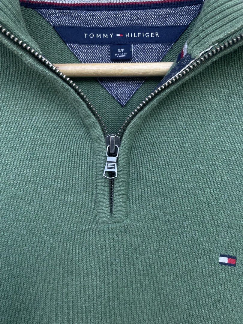Tommy Hilfiger Green 1/4 Zip Sweater (Category: Coats, Jackets and Outerwear) located in Mataasnakahoy. Submitted by zero4thrift (Listing ID 1448097333, Image 3). Description: This Tommy Hilfiger sweater is a green cotton quarter-zip pullover featuring a small embroidered flag logo on the chest. - Green Tommy Hilfiger 1/4 zip sweater - Small flag logo on chest - Grey trim on collar - 100% Cotton - Size: S/P - Ideal for casual wear - actual size 2