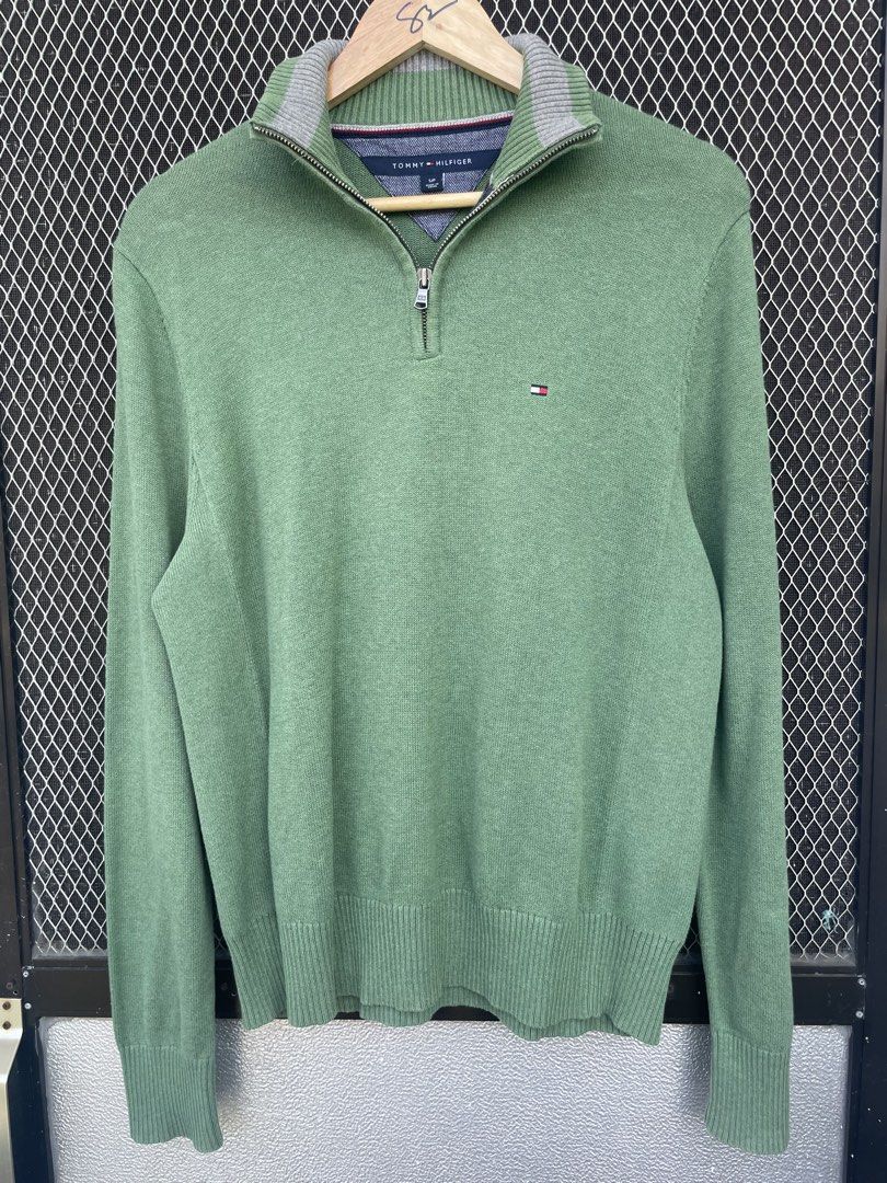 Tommy Hilfiger Green 1/4 Zip Sweater (Category: Coats, Jackets and Outerwear) located in Mataasnakahoy. Submitted by zero4thrift (Listing ID 1448097333, Image 1). Description: This Tommy Hilfiger sweater is a green cotton quarter-zip pullover featuring a small embroidered flag logo on the chest. - Green Tommy Hilfiger 1/4 zip sweater - Small flag logo on chest - Grey trim on collar - 100% Cotton - Size: S/P - Ideal for casual wear - actual size 2