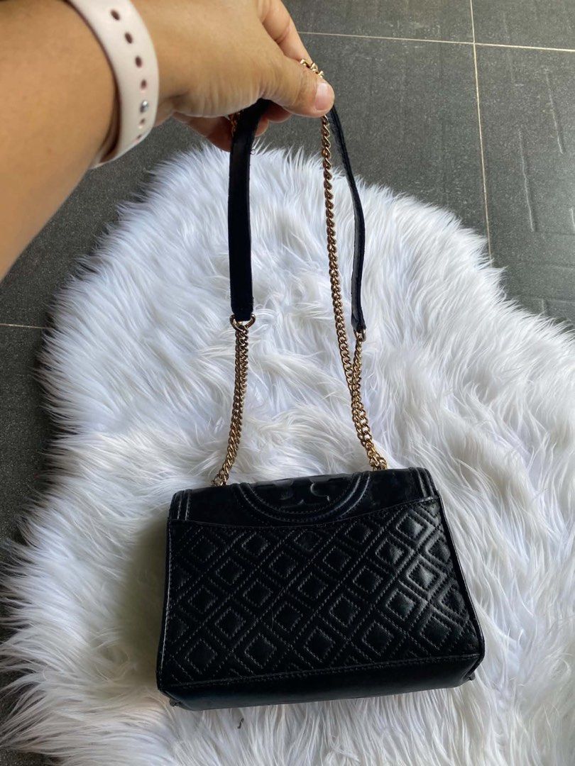 Tory Burch Black Leather Quilted Chain Shoulder Bag (Category: Luxury Bags & Wallets) located in Dumanjug. Submitted by avegailbal20275 (Listing ID 1448082501, Image 1). Description: - Authentic Tory Burch black shoulder bag - Genuine leather with classic quilted stitching - Elegant gold chain strap - Interior features Tory Burch logo lining - Note: 'Made in China' tag present.
