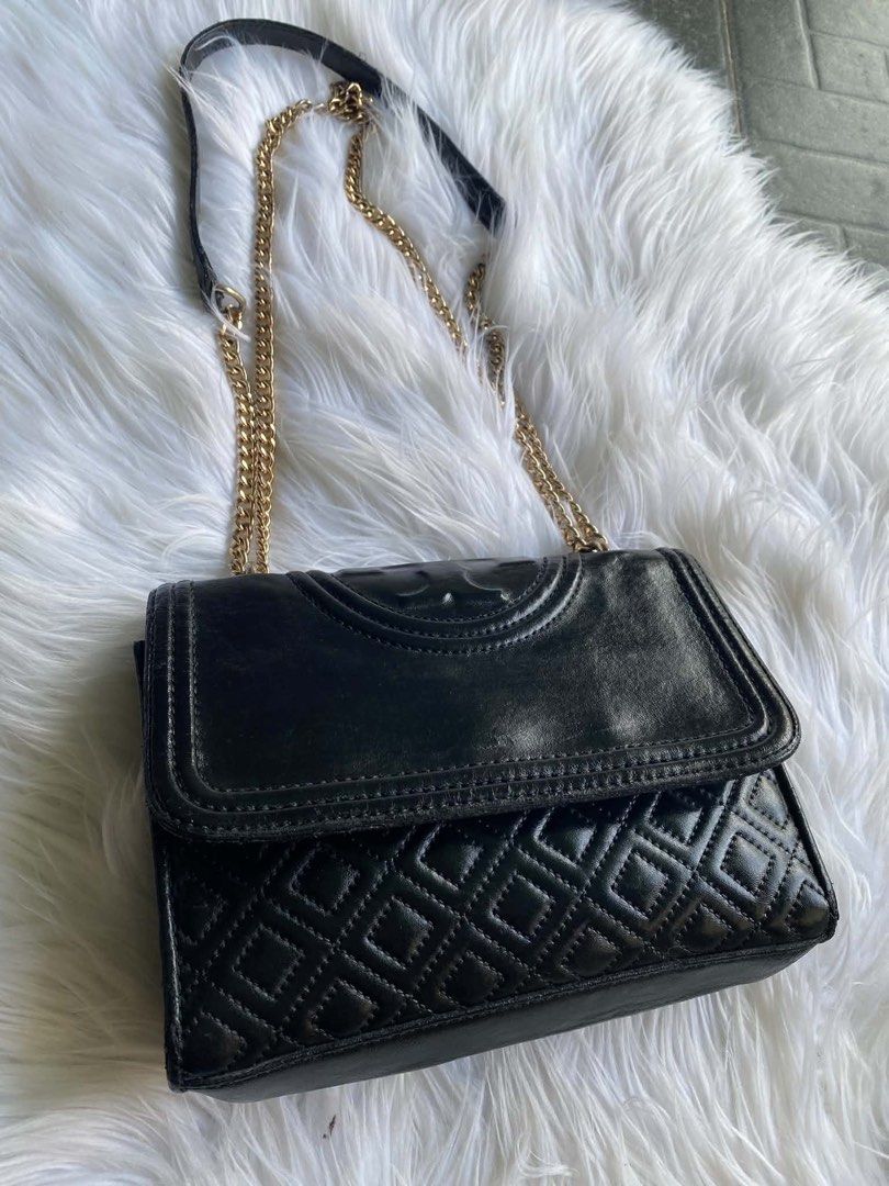 Tory Burch Black Leather Quilted Chain Shoulder Bag (Category: Luxury Bags & Wallets) located in Dumanjug. Submitted by avegailbal20275 (Listing ID 1448082501, Image 2). Description: - Authentic Tory Burch black shoulder bag - Genuine leather with classic quilted stitching - Elegant gold chain strap - Interior features Tory Burch logo lining - Note: 'Made in China' tag present.
