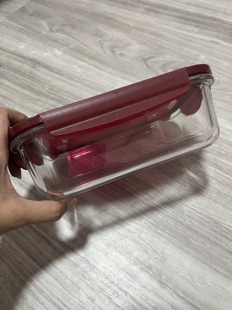 Tupperware Glass Food Container with Lid (Category: Food Organization & Storage) located in Quezon City. Submitted by larenaxoxo (Listing ID 1448272073, Image 2). Description: - Rectangular glass food container - Comes with a dark red Tupperware lid - Ideal for storing leftovers or meal prepping - Sturdy glass base - Lid seals well for freshness - Easy to clean and use.