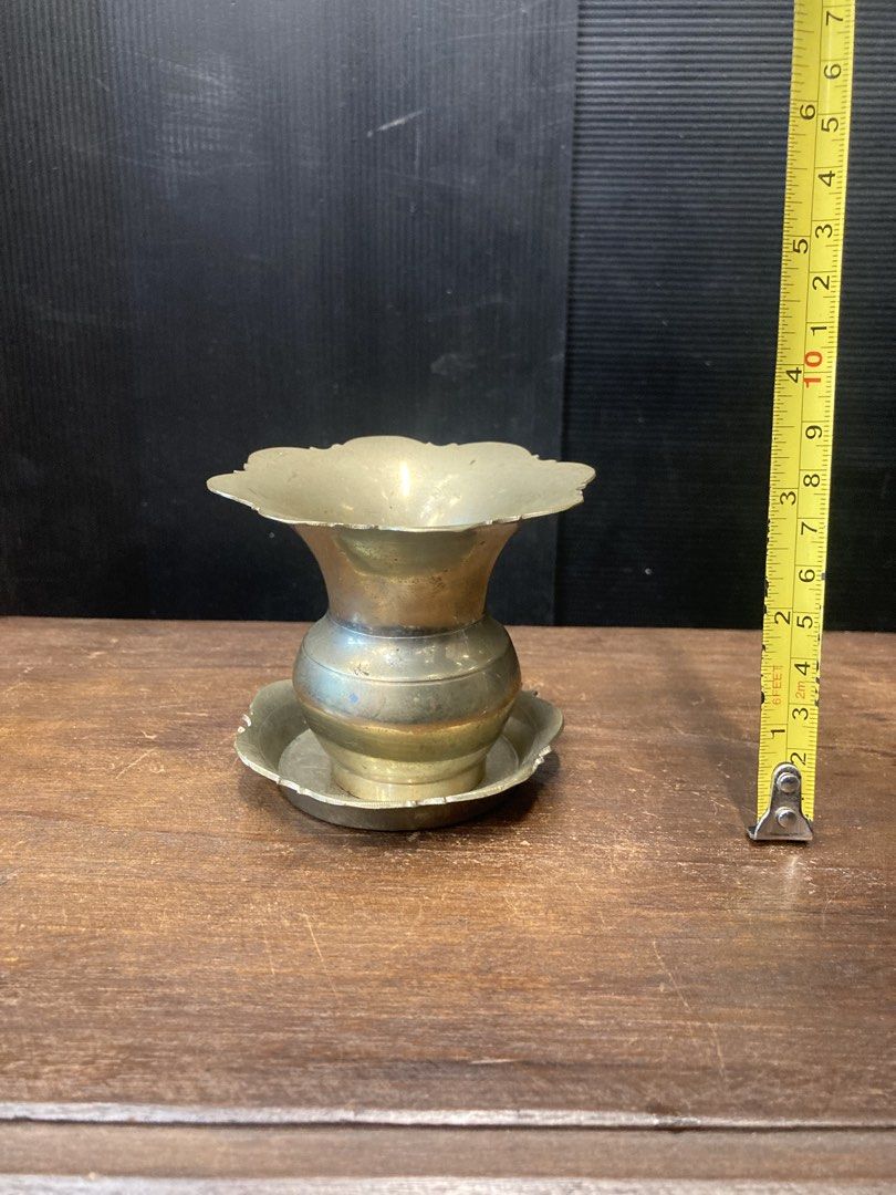 Vintage Brass Sirih (Category: Vases & Decorative Bowls) located in Kuala Lumpur. Submitted by gninevintage (Listing ID 1448249007, Image 3). Description: - Set of 2 vintage brass vases - Features elegant scalloped rims - Includes matching saucers - Ideal for small floral arrangements or decorative display - Beautiful aged patina adds antique charm - Approximately 5 inches tall.
