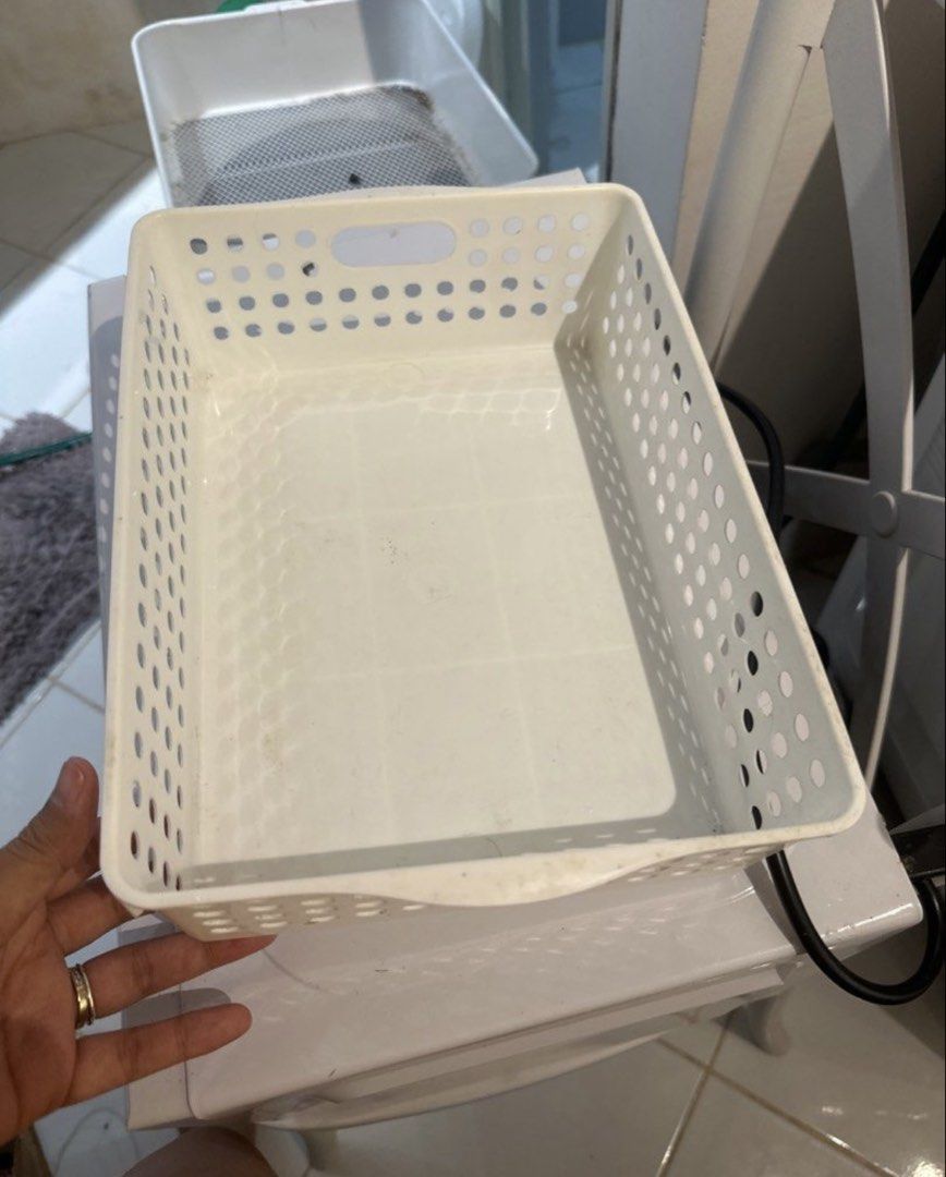 White Plastic Storage Baskets (Set of 2) (Category: Storage Boxes & Baskets) located in Quezon City. Submitted by trisssh0 (Listing ID 1448090896, Image 1). Description: - Set of 2 white plastic storage baskets - Features a stylish perforated design - Convenient side handles for easy carrying - Versatile for organizing shelves, drawers, and countertops - Suitable for kitchen, bathroom, or office use - Great for storing small items.