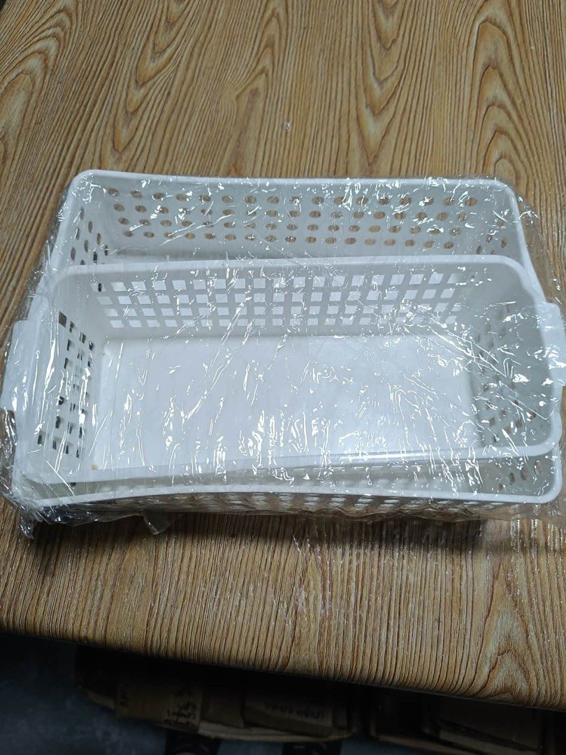 White Plastic Storage Baskets (Set of 2) (Category: Storage Boxes & Baskets) located in Quezon City. Submitted by trisssh0 (Listing ID 1448090896, Image 3). Description: - Set of 2 white plastic storage baskets - Features a stylish perforated design - Convenient side handles for easy carrying - Versatile for organizing shelves, drawers, and countertops - Suitable for kitchen, bathroom, or office use - Great for storing small items.