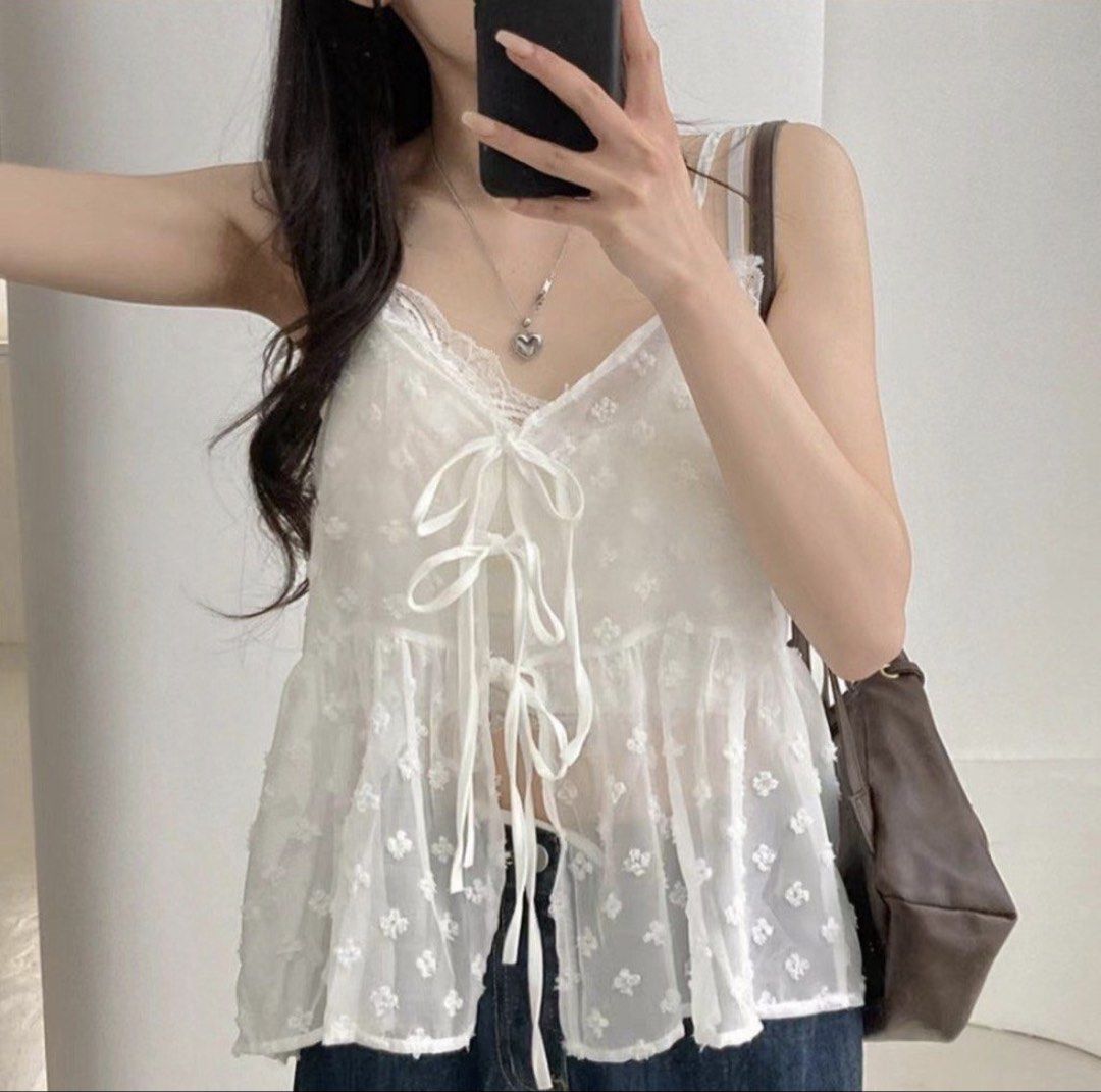 White Sheer Tie-Front Babydoll Top (Category: Blouses) located in Manila. Submitted by cami0110 (Listing ID 1448175139, Image 2). Description: - White sheer babydoll top - Textured floral pattern all over - Ribbon ties at the front - Thin spaghetti straps - Flowy, babydoll silhouette - Ideal for layering or as a beach cover-up.