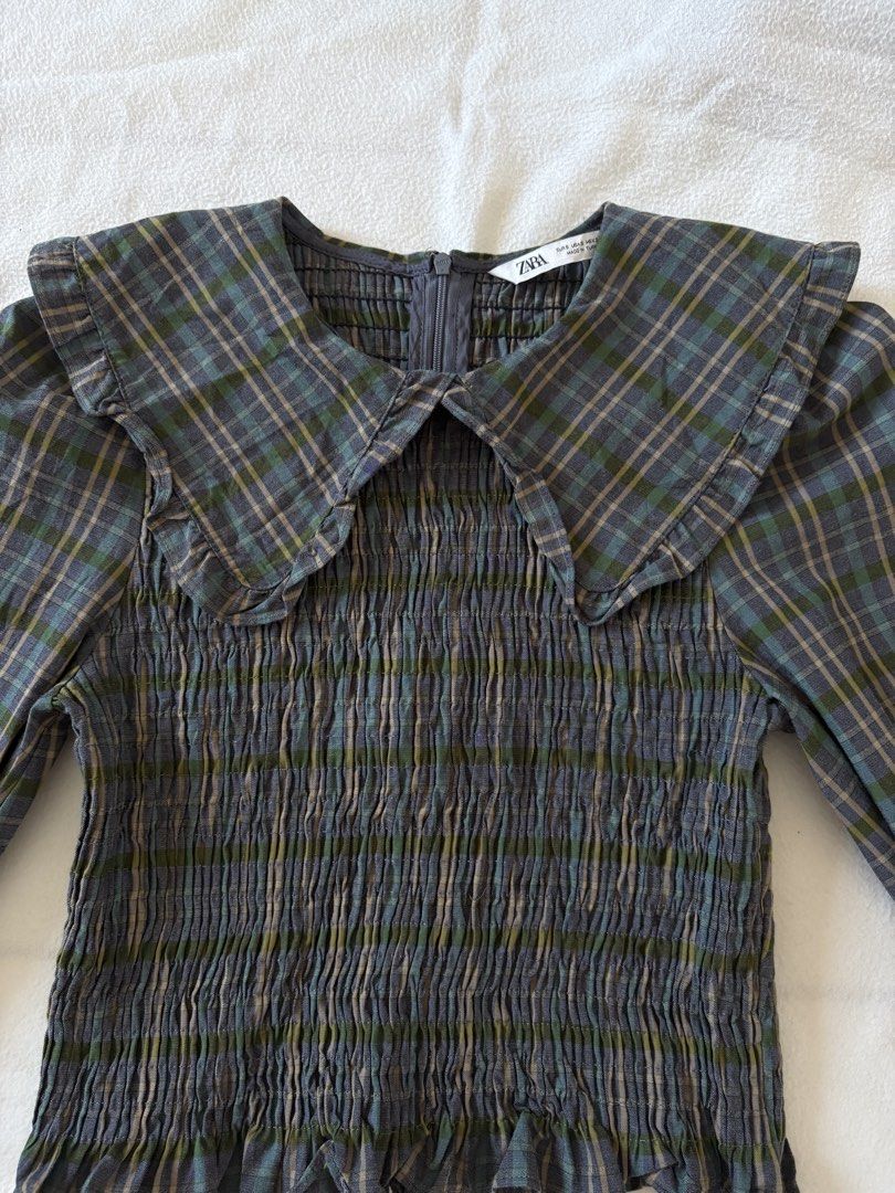 Zara Plaid Smocked Collared Long Sleeve Top (Category: Blouses) located in Taguig. Submitted by cftbncs (Listing ID 1448078203, Image 2). Description: - Zara grey and green plaid long sleeve top - Smocked bodice - Ruffled collar - Zipper closure at the back - Balloon sleeves with elastic cuffs - Pairs well with high-waisted jeans or skirts.