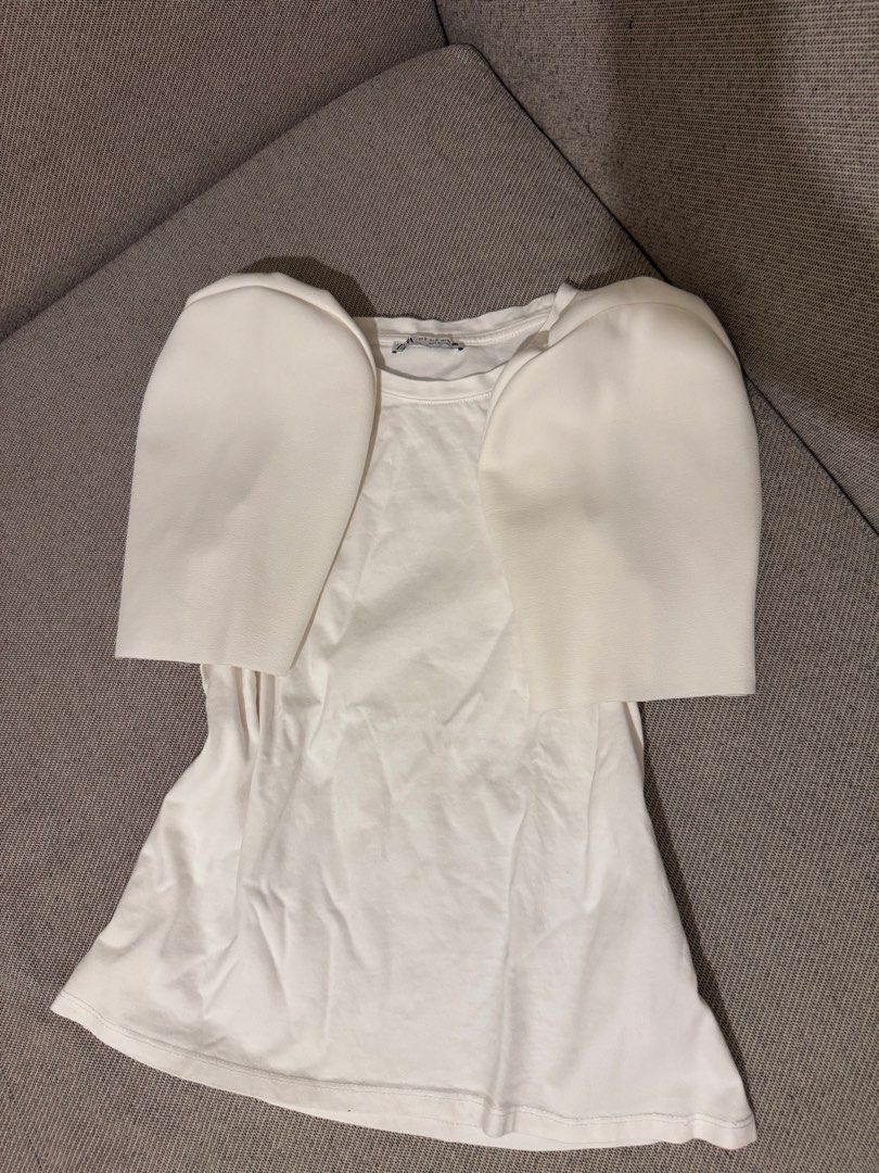 ZARA White T-shirt with Statement Puffy Sleeves (Category: Shirts) located in Mandaluyong City. Submitted by cartmyitems (Listing ID 1448190908, Image 1). Description: - Brand: ZARA - Color: White - Style: T-shirt with unique structured puffy sleeves - Sleeve Texture: Smooth, almost leather-like - Body Material: Soft cotton - Size: S - Key Feature: Statement piece to elevate casual outfits.