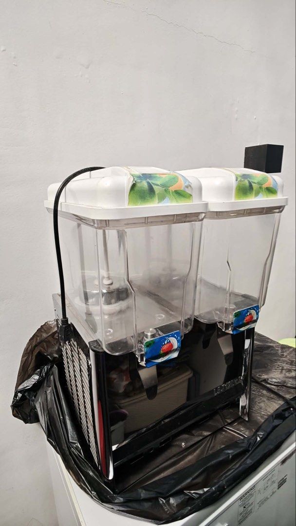 2-Tank Commercial Juice Dispenser (Category: Pitchers & Dispensers) located in Marikina City. Submitted by heytofu (Listing ID 1448313687, Image 1). Description: - Commercial-grade 2-tank juice dispenser - Model: LSJ12L x 2 - Features two clear plastic tanks with lids - Durable shiny metal base - Includes a black power cord - Ideal for cafes, restaurants, and other food service establishments RFS: nag close na ang food stall and di masyado nagami
