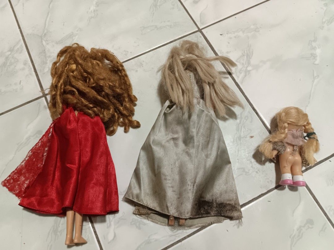 3 Vintage Dolls with Dresses (Category: Kids Toys) located in Manila. Submitted by caaths_collection (Listing ID 1448479445, Image 2). Description: - Set of 3 vintage dolls - Doll 1: Grey gown, long styled hair - Doll 2: Red lace dress, long styled hair - Doll 3: Smallest doll, pink dress, long styled hair - Visible wear on dresses and dolls, adding to vintage charm - Perfect for doll collectors or for play.