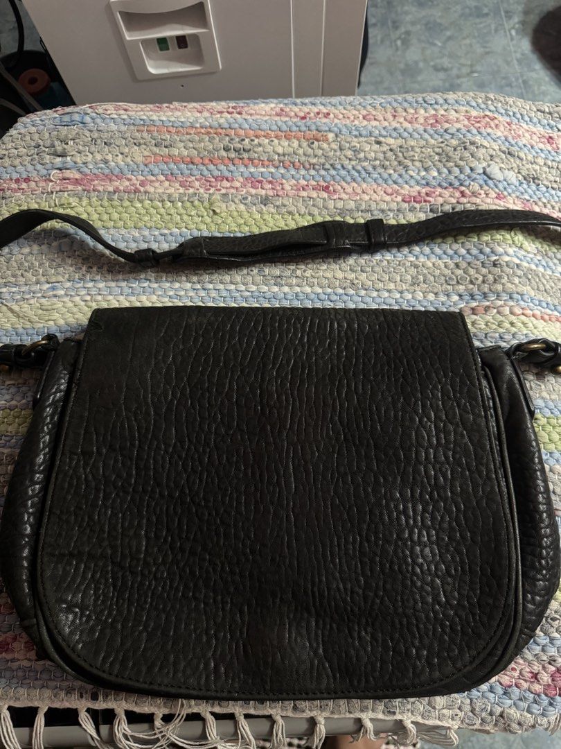 Alexander Wang Black Leather Crossbody Bag (Category: Luxury Bags & Wallets) located in Makati City. Submitted by vinsanity41546 (Listing ID 1448446824, Image 1). Description: - Authentic Alexander Wang black leather crossbody bag - Textured leather exterior for a stylish look - Features a zippered interior pocket for secure storage - Main compartment includes a divider for organization - Adjustable strap for comfortable, customizable wear - Idea