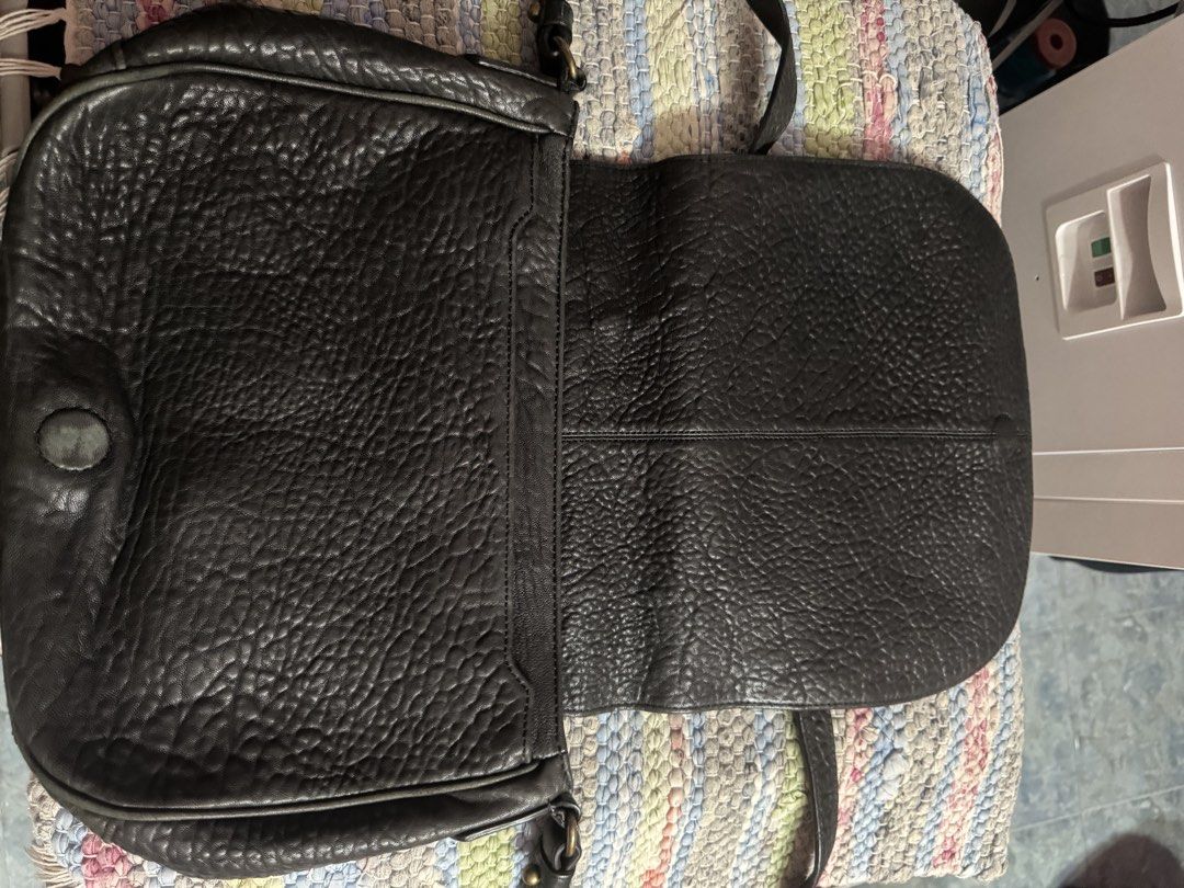 Alexander Wang Black Leather Crossbody Bag (Category: Luxury Bags & Wallets) located in Makati City. Submitted by vinsanity41546 (Listing ID 1448446824, Image 2). Description: - Authentic Alexander Wang black leather crossbody bag - Textured leather exterior for a stylish look - Features a zippered interior pocket for secure storage - Main compartment includes a divider for organization - Adjustable strap for comfortable, customizable wear - Idea