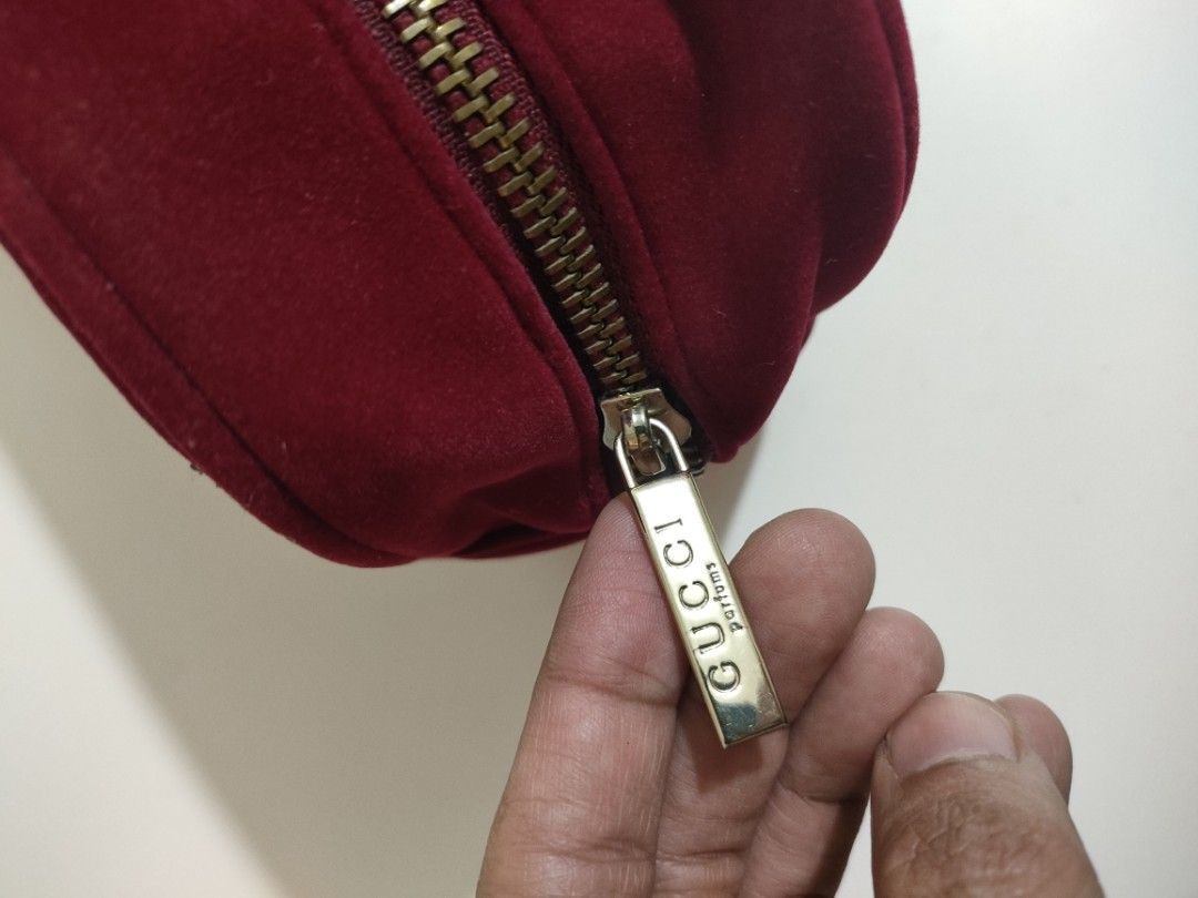 Authentic Red Velvet Gucci Cosmetic Bag (Category: Luxury Bags & Wallets) located in Caloocan City. Submitted by rjb21 (Listing ID 1448283174, Image 2). Description: - Authentic Red Velvet Gucci Cosmetic Bag - Features a secure gold zipper closure with Gucci Perfume tag - Interior includes a small Gucci tag - Minor marks present on exterior velvet and interior lining - Zipper functions smoothly - Ideal for storing makeup or travel essentials.
