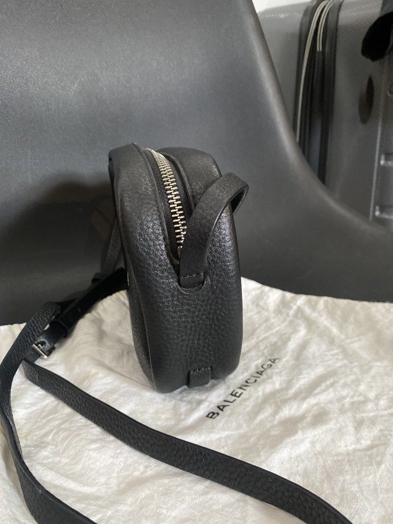 Balenciaga Black Leather Camera Bag (Category: Luxury Bags & Wallets) located in Las Pinas. Submitted by harper_preloved (Listing ID 1448394519, Image 3). Description: - Japan Flea market finds - Authentic Balenciaga black leather camera bag - Features a pebbled leather texture - Accented with silver hardware and zipper - Adjustable strap for comfortable wear - Includes original dust bag - Ideal for everyday essentials and style.