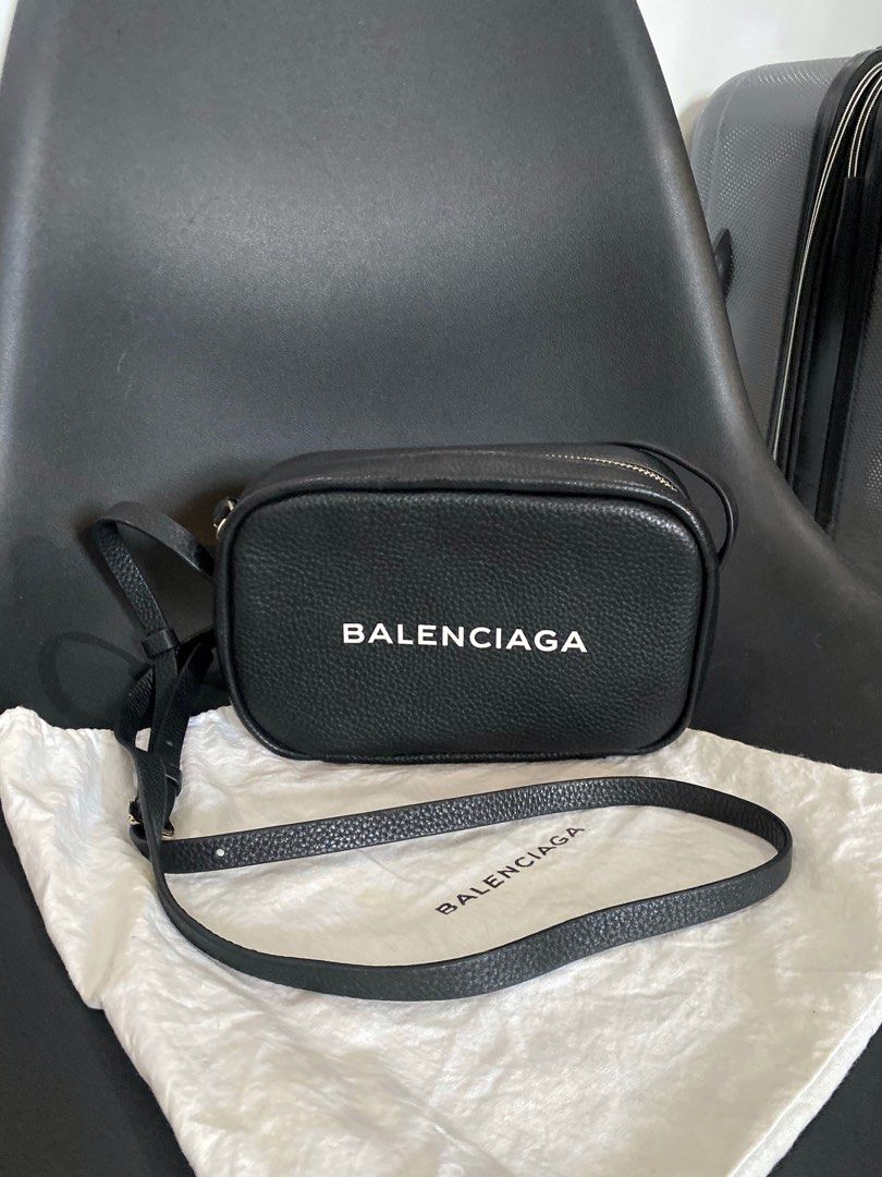 Balenciaga Black Leather Camera Bag (Category: Luxury Bags & Wallets) located in Las Pinas. Submitted by harper_preloved (Listing ID 1448394519, Image 1). Description: - Japan Flea market finds - Authentic Balenciaga black leather camera bag - Features a pebbled leather texture - Accented with silver hardware and zipper - Adjustable strap for comfortable wear - Includes original dust bag - Ideal for everyday essentials and style.