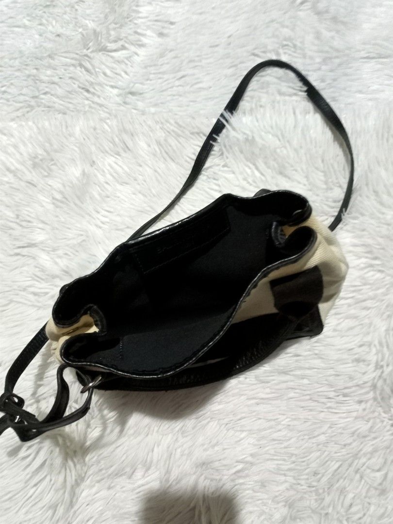 Balenciaga Paris Canvas & Leather Mini Handbag (Category: Luxury Bags & Wallets) located in Polomolok. Submitted by aldrex_18 (Listing ID 1448346469, Image 3). Description: - Balenciaga Paris mini bag - Canvas body with black leather trim and handles - Includes adjustable shoulder strap - Black interior - Shows some signs of wear on leather and canvas - Ideal for carrying essentials.