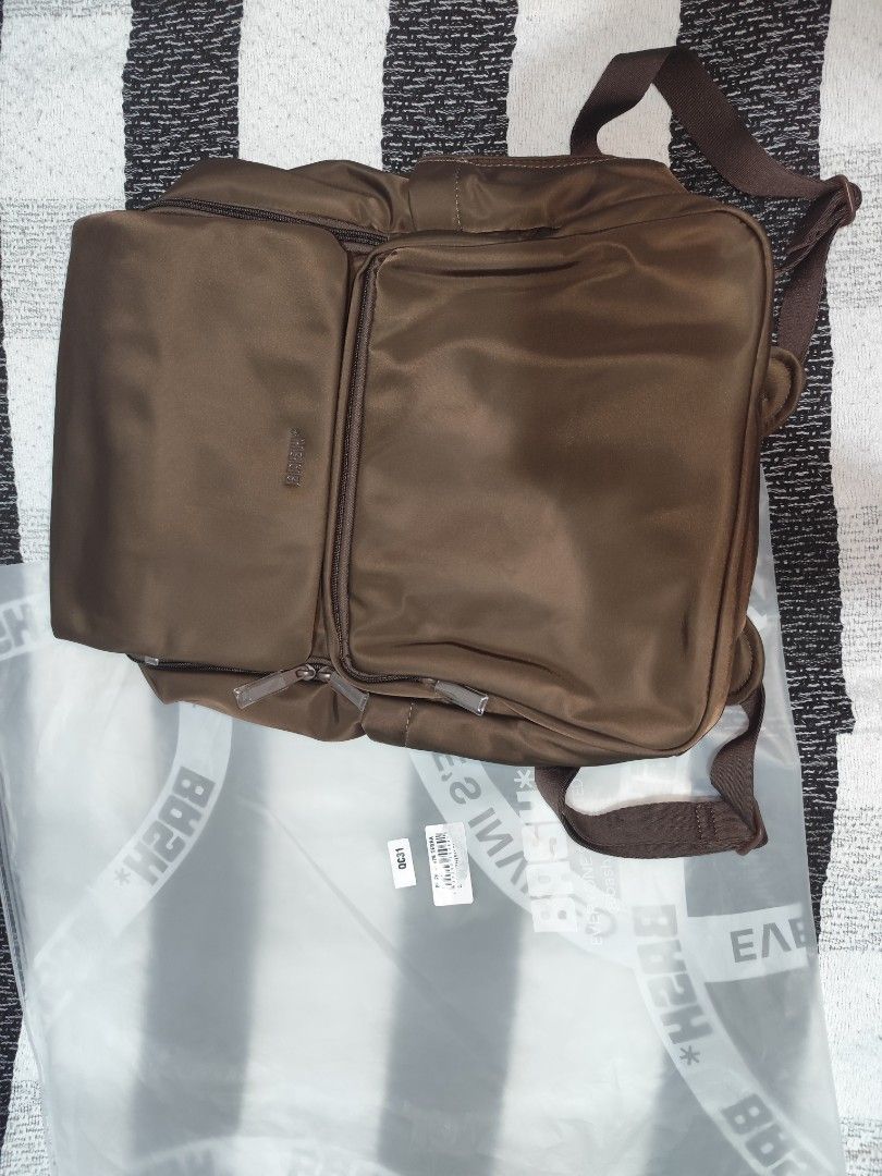 BASH* Brown Nylon Messenger Bag with Dustbag and Tags (Category: Luxury Bags & Wallets) located in Silang. Submitted by eunicenico82586 (Listing ID 1448429213, Image 1). Description: - Brand: BASH* - BRAND NEW - Color: TERRA - Material: Nylon - Style: Messenger Bag - Features: Multiple compartments, zippers - Includes: Original dustbag and tags - Ideal for: Everyday use, travel -ORIGINAL BASH BAG.