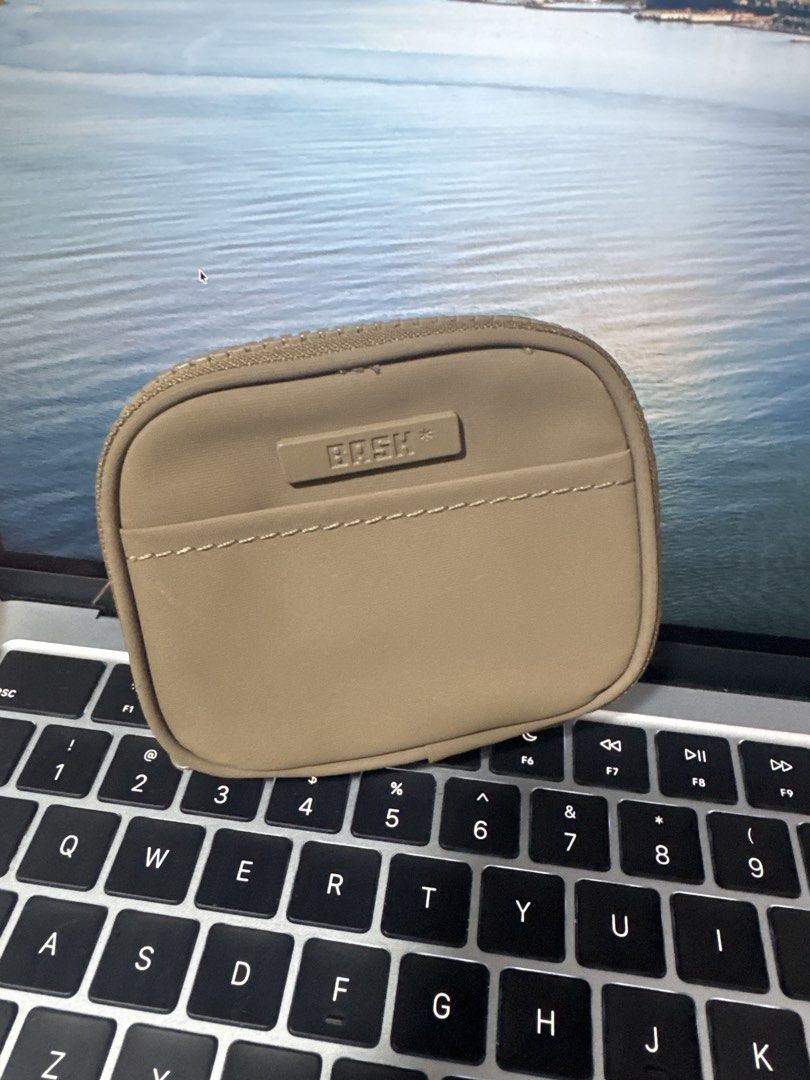 BASH Coin Pouch Wallet (Category: Purses & Pouches) located in Quezon City. Submitted by yaaasqueen (Listing ID 1448453468, Image 1). Description: - BASK beige coin pouch - Zipper closure - Front pocket with stitching detail - Ideal for organizing small essentials - Compact size, fits easily in bags or pockets.