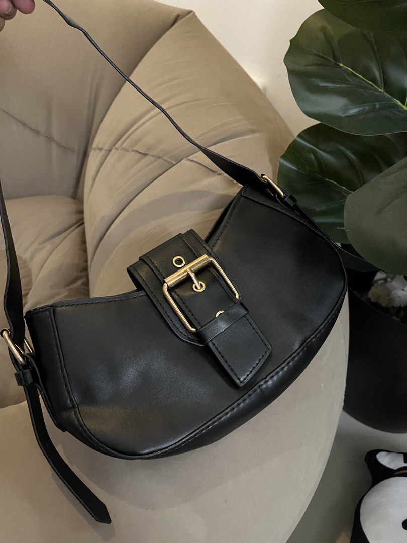 Black Shoulder Bag with Gold Buckle (Category: Shoulder Bags) located in Trece Martires City. Submitted by miaaamic (Listing ID 1448299983, Image 2). Description: - Cute black shoulder bag - Features a nice gold buckle detail on the front flap - Adjustable strap for comfortable wear - Plenty of space inside for your essentials - Versatile for everyday use or a night out.