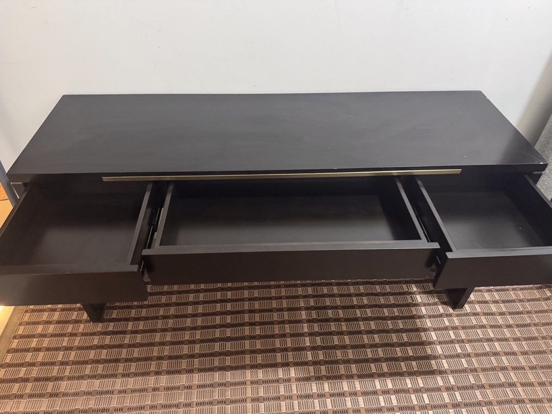 Black Solid Study Table with Drawers (Category: Tables & Sets) located in Kuala Lumpur. Submitted by heniareen (Listing ID 1448325976, Image 3). Description: - Sleek black console table - Features three convenient drawers for storage - Elegant gold handles add a touch of luxury - Ideal for your entryway or as a chic vanity - Reason for selling: Moving house - 150mm length, width 45mm, height 75mm .