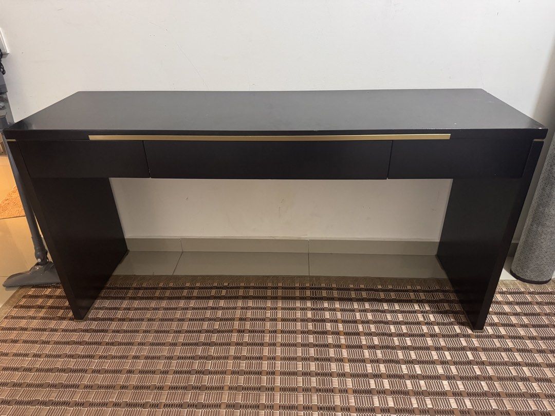 Black Solid Study Table with Drawers (Category: Tables & Sets) located in Kuala Lumpur. Submitted by heniareen (Listing ID 1448325976, Image 1). Description: - Sleek black console table - Features three convenient drawers for storage - Elegant gold handles add a touch of luxury - Ideal for your entryway or as a chic vanity - Reason for selling: Moving house - 150mm length, width 45mm, height 75mm .