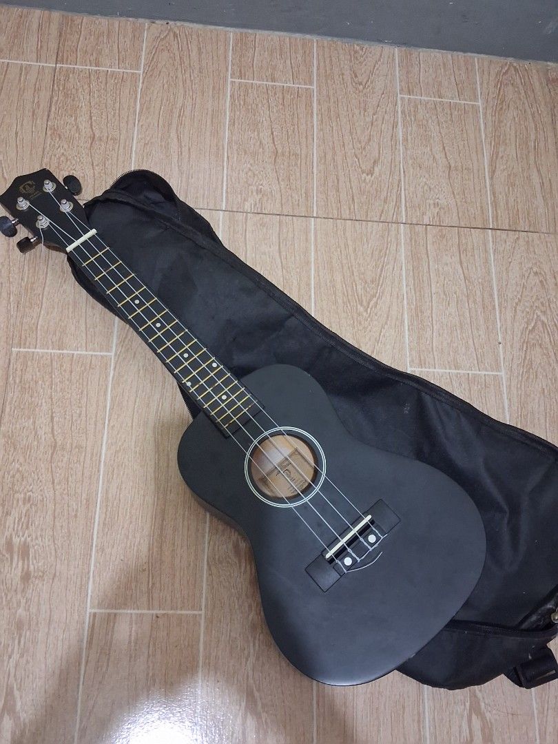 Black Ukulele with Gig Bag (Category: Musical Instruments) located in Quezon City. Submitted by azii.chloeaa (Listing ID 1448328553, Image 1). Description: - Black ukulele - Includes black gig bag for easy transport - Ideal for beginners or new players - Black tuners and white strings - Ready to play right out of the box!.