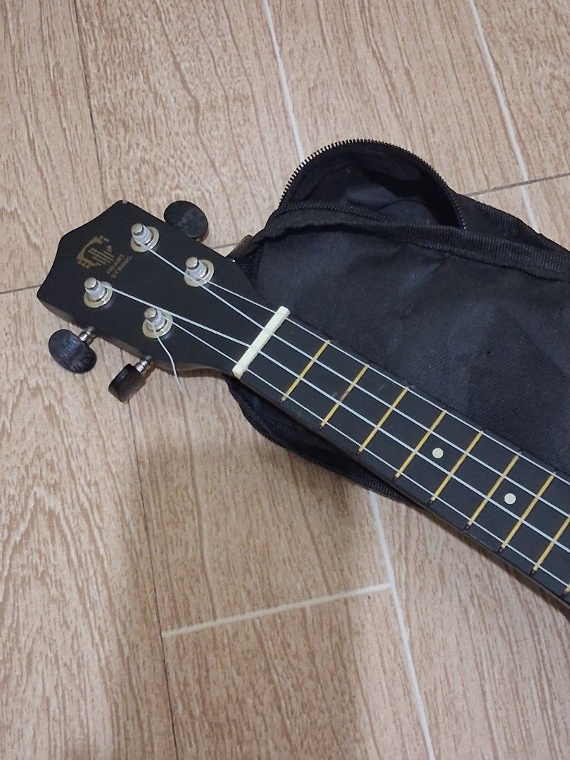 Black Ukulele with Gig Bag (Category: Musical Instruments) located in Quezon City. Submitted by azii.chloeaa (Listing ID 1448328553, Image 3). Description: - Black ukulele - Includes black gig bag for easy transport - Ideal for beginners or new players - Black tuners and white strings - Ready to play right out of the box!.